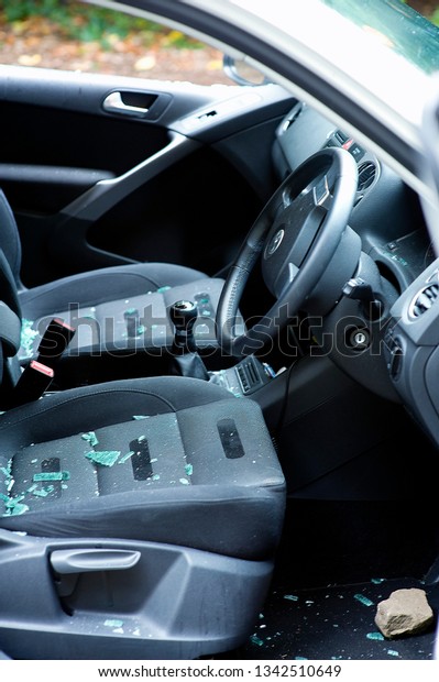 Vehicle Damaged\
with Glass Shattered on the seat and floor with the rock in the\
foot well left by a Car\
Burgular.