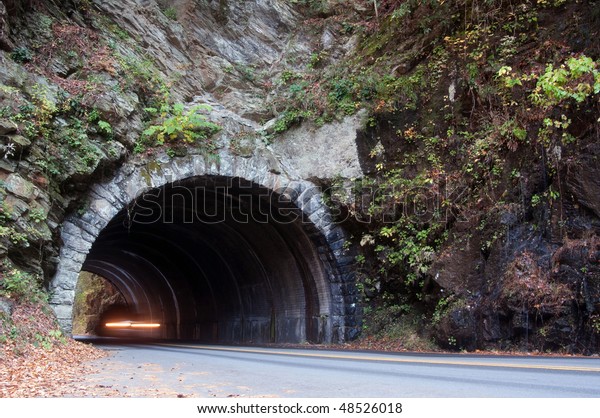 Vehicle drives through a tunnel through the\
mountains of Tennessee. Motion blur in\
car.