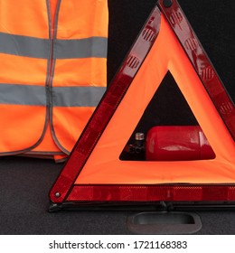 Vehicle Emergency Tools Kit, Red Warning Triangle, High-visibility Vest And Fire Extinguisher In The Trunk Of The Car. Elements Of The Essentials For A Passenger Automobile