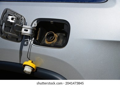 Vehicle with fuel door open and fuel cap removed.
