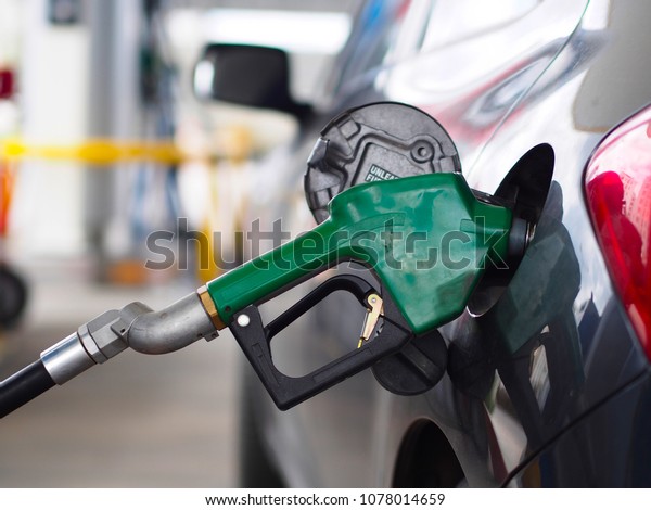 vehicle at fuel\
station and close-up fuel\
pump