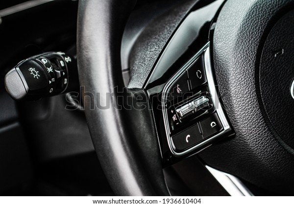 Vehicle interior of a modern car.\
Multiple buttons on the steering wheel to accept or reject calls\
from the phone close up view. Answer and reject phone\
buttons.