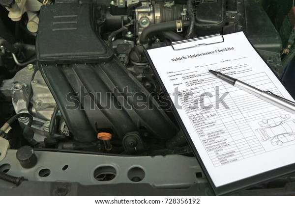 Vehicle maintenance\
checklist on car\
engine.