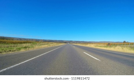 Vehicle POV, Driving Along Wide, Flat Open Highway Through McLaren Vale South Australia.