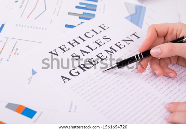 vehicle\
sales agreement concept, documents on the\
desktop