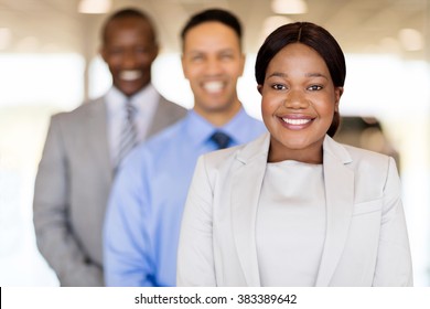 Vehicle Sales Team Standing In A Row Inside Car Showroom