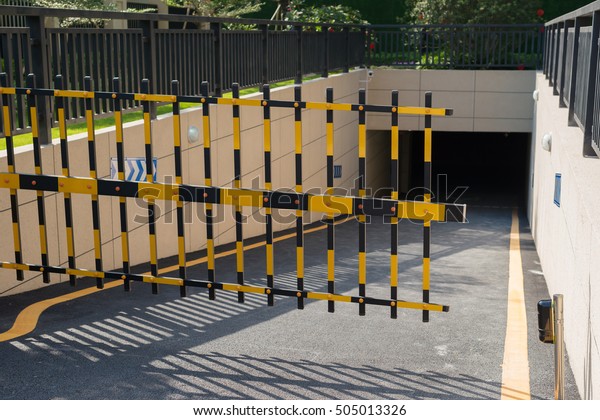 Vehicle security barrier closed - entrance to an\
underground car park