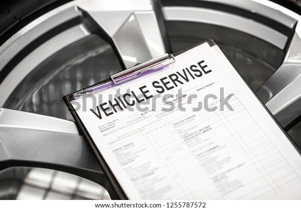 Vehicle service\
agreement lying on the\
wheel