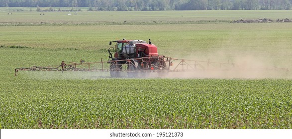 Vehicle Spraying Herbicide Onto A Farm Field Of Corn