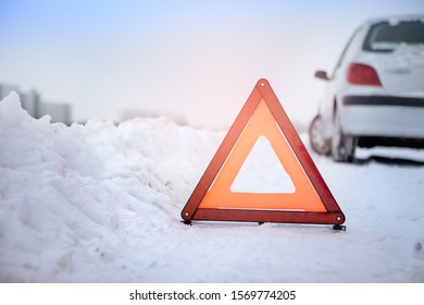 Vehicle Stuck On A Snowy Road, Protected By A Hazard Sign