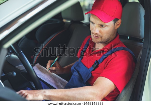 vehicle technical inspection - man sitting inside the\
car and ch