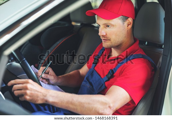 vehicle technical inspection - mechanic\
sitting inside the car and checking control\
panel