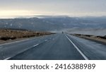 Vehicle traveling on the interstate 90 highway road in Washington State, USA, during a wet, cold and raining day