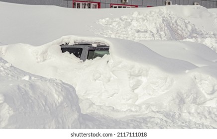 Vehicles covered with snow during a winter blizzard on the road.The roads are snow-blocked. - Shutterstock ID 2117111018