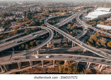 Vehicles Driving on a Spaghetti Interchange at Sunset - Shutterstock ID 2060157572