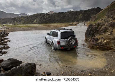 Vehicles Fording River In Landmannalaugar, Iceland