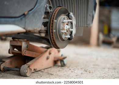 Vehicles on a lifting platform to change brake pads. - Shutterstock ID 2258004501