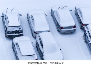 Vehicles Parked On City Street Covered By Deep Snow On Cold Frosty Winter Day.