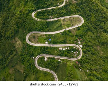 Vehicles running over the intestine road and hills in mountain province of Bukidnon. Mindanao, Philippines.