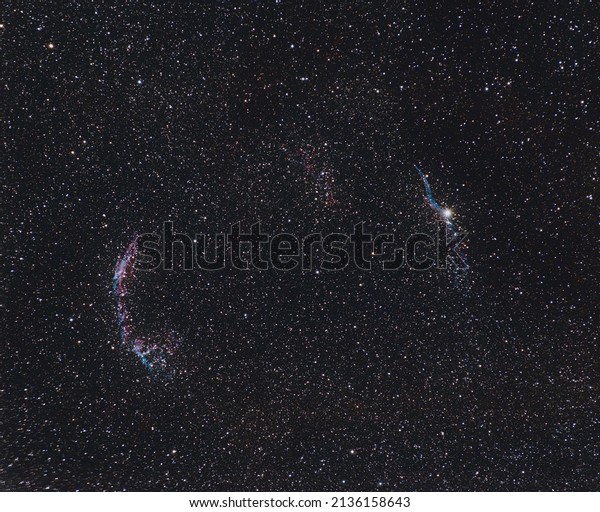 Veil nebula\
with shining stars in the\
background