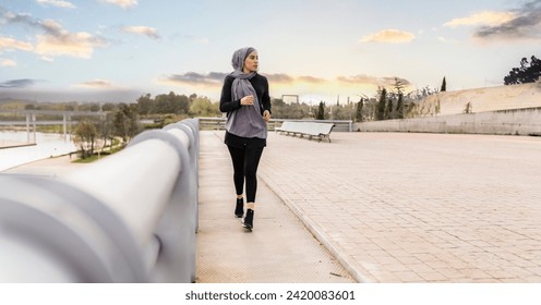 Veiled woman is running through the park outdoors  - Powered by Shutterstock