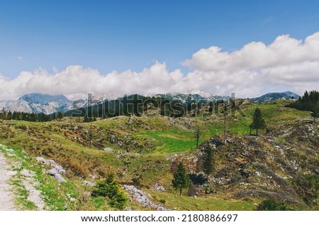 Velika Planina or Big Pasture Plateau in the Kamnik Alps, Slovenia. Mountain cottage hut or house on green hill. Alpine meadow landscape. Eco farming.