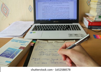 Veliko Tarnovo / Bulgaria - May 13, 2017: Bulgarian Law Student Learning For Exam Called Conflict Of Laws. He Draws Diagrams To Make The Process Easier And Efficient. He Learns From Laptop And Books.