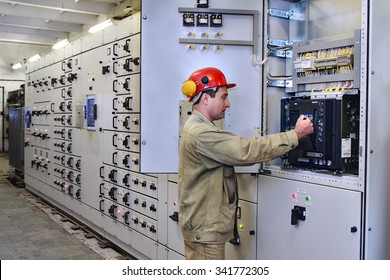Veliky Novgorod, Russia - June 26, 2007:  Service for high voltage switchgear, electrical engineer maintenance switchboard room,  chemical Plant.