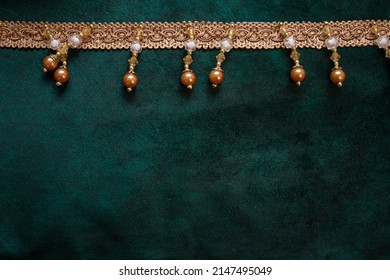 velour fabric texture, background, green. Velvet velour cloth background with glowing light and dark shadows. Background for theater and fashion design themes.