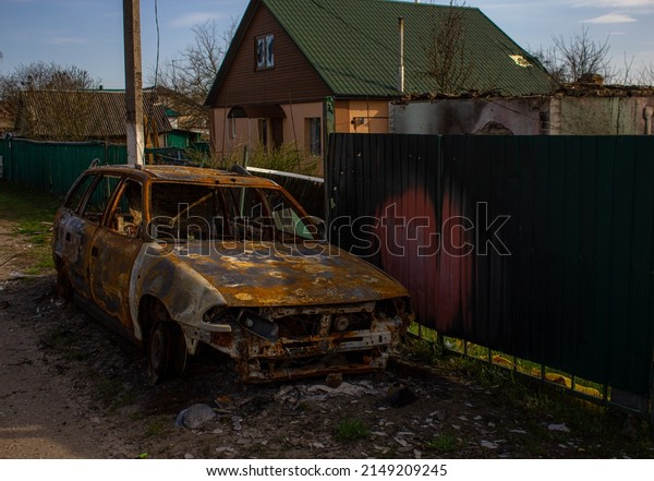 Velyka Dymerka, Kyiv region, Ukraine - April\
2022: War Ukraine Russia. The ruins of a house and a blown up car\
of civilians after the bombing by the Russian army. Damaged car and\
house after a missile