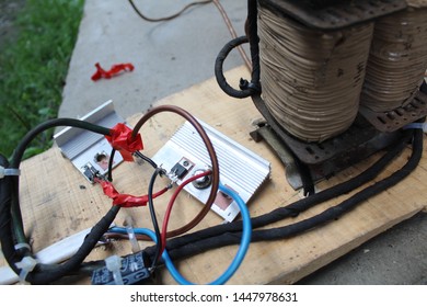Velykyi Bychkiv, Transcarpathian region - July 10, 2019: Microcircuits with tracks, resistors, hermetic contours, transistors, diodes, capacitors, transformers, coils, a large number of colored cable. - Shutterstock ID 1447978631