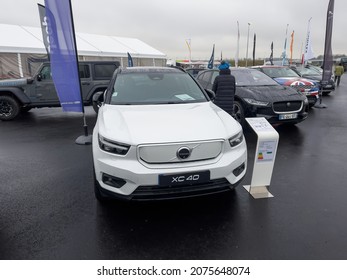 Vendenheim, France - Nov 14, 2021: Woman Walking With Kid In Stroller Admiring The New Electric Car From Volvo XC 40 Model With Price Tag 62000 Euros