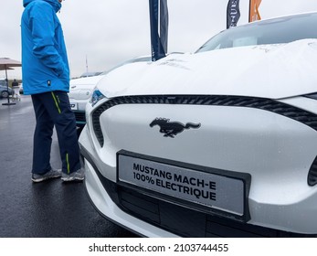 Vendenheim, France - Nov 14, 2021: Man customer looking before buying at the outdoor parked new Mustang Mach-E car electric EV car