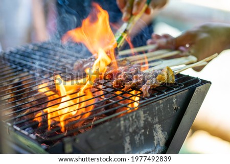 Similar – Man cooking on a barbecue