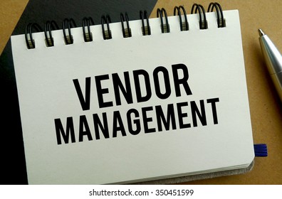 Vendor management memo written on a notebook with pen