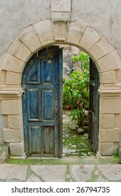 A Venetian arched door,open into garden courtyard
