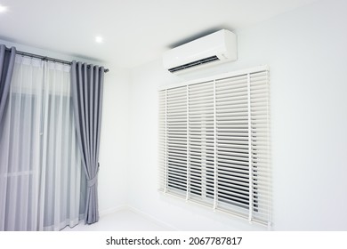 Venetian blind and air conditioner (ac) wall mount or indoor unit of split system consist of electric fan, filter and evaporator coil for climate, temperature and humidity control in room of home.