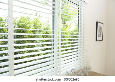  venetian blinds by the window