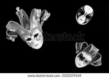 Venetian carnival masks on the black background. Top view. Copy space.