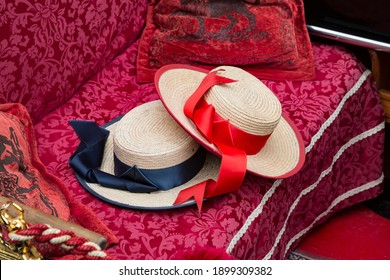 Venetian gondolier's red and blue hats on the sitting bench of a gondola, Venice, Italy