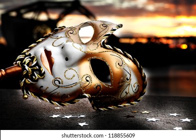 Venetian Mask by the River Bridge with Sunset