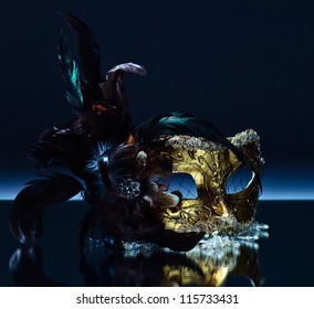 The Venetian Mask With Feather On A Mirror Table