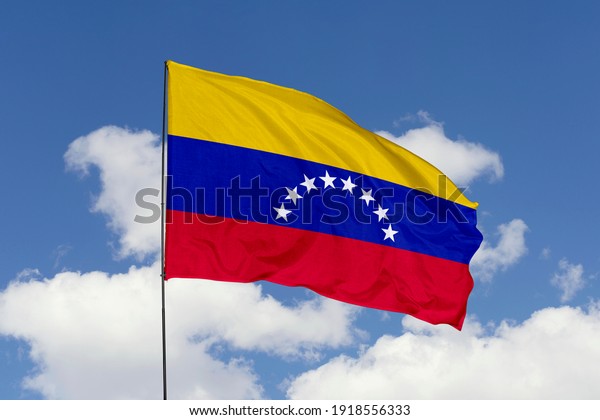 Venezuela\
flag isolated on the blue sky with clipping path. close up waving\
flag of Venezuela. flag symbols of\
Venezuela.