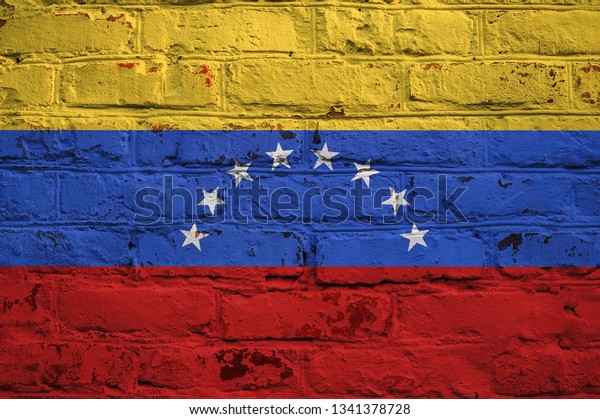 Venezuelan flag on brick\
wall background.