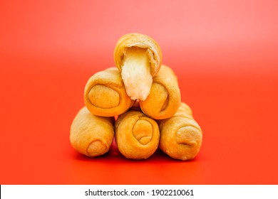 Venezuelan Tequenos Cheese Fingers Piled With Melting Cheese Falling In Red Background  Horizontal Shot 