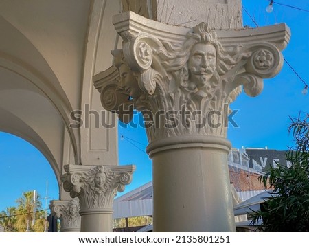 Venice Beach, Los Angeles, California -2022: Abbott Kinney’s Italianate facades and arcades featuring his face. Windward Avenue decorated by rows of columns with Venetian theme capitals. 