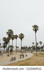 Venice, CA - July 4, 2009: Few Bike Riders On The Trail That Goes Around The Beach. The Beach Is A Popular Tourist Destination And A Workout Location. Arnold Schwarzenegger Used To Work Out Here.