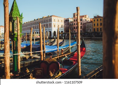 Venice Channel With Pier With Gondolas, Gandols  Around The Beautiful Architecture Of A Sinking City At Sunset With Beautiful Golden Light