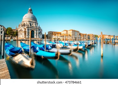 Venice cityscape view on Santa Maria della Salute basilica with gondolas on the Grand canal in Venice. Long exposure image technic with motion brured boats
