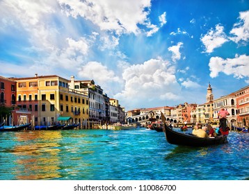 Venice Grand canal with gondolas and Rialto Bridge, Italy in summer bright day